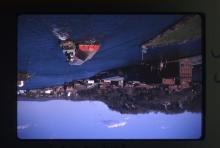 A tugboat and barge depart past Island Dock and Rondout ca. 1966.